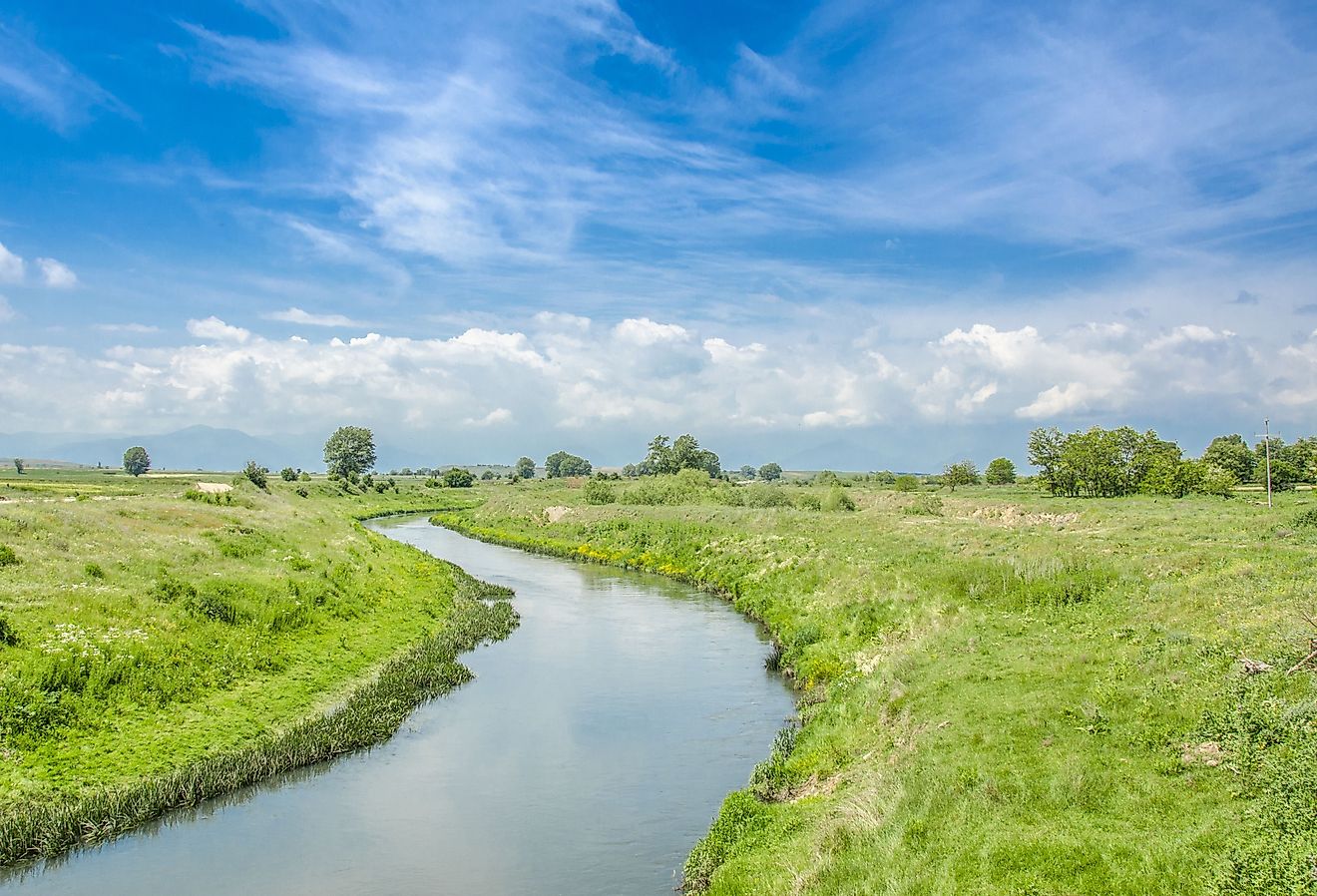 Crna River weaves through grass in North Macedona. Image credit Pargovski Jove via Shutterstock. 