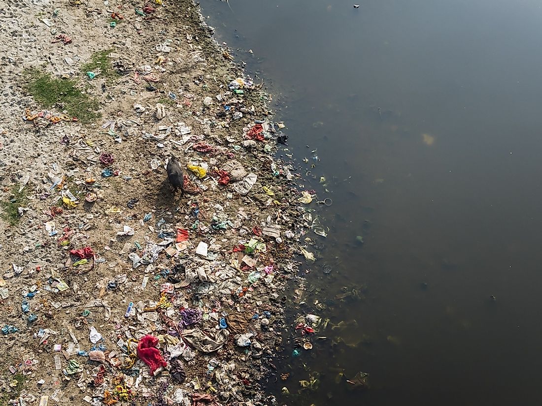 In several places along its course, the Citarum River is so heavily loaded with wasters that its water is hardly visible.