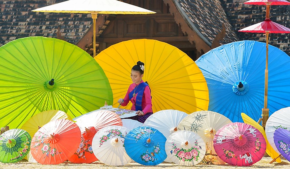 Thai woman painting umbrellas in Chiang Mai, Thailand.