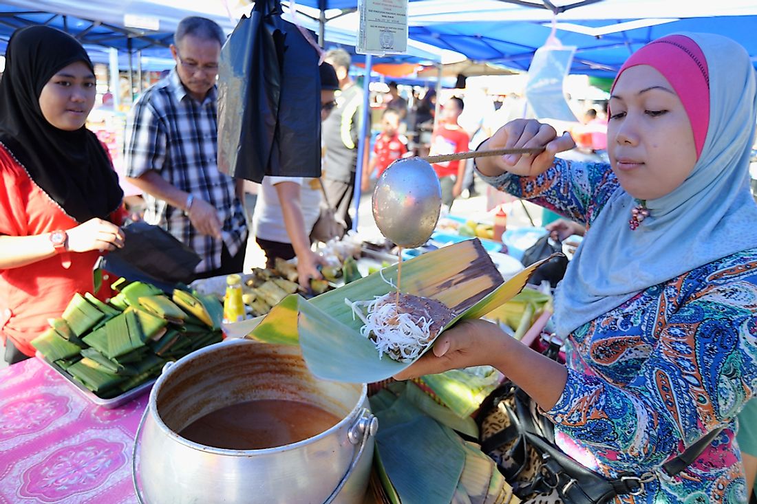 Women at a market in Brunei. Editorial credit: Lano Lan / Shutterstock.com. 