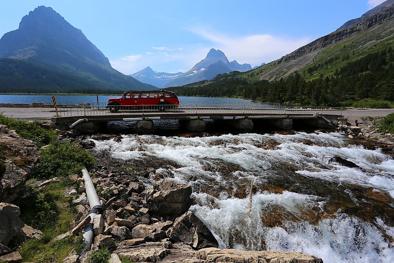 Red Tour Bus passing through the Glacier National Park, Montana.