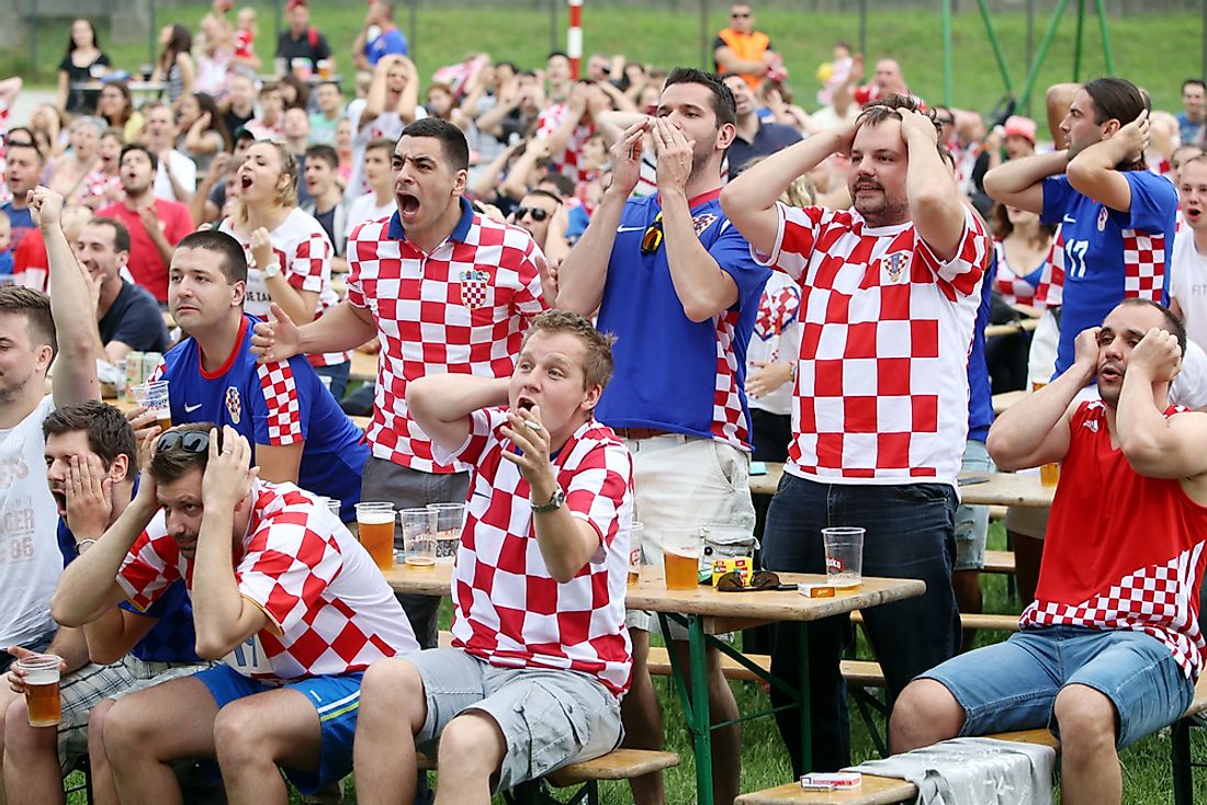 Croatian football fans cheer on a match.  Editorial credit: Goran Jakus / Shutterstock.com. 