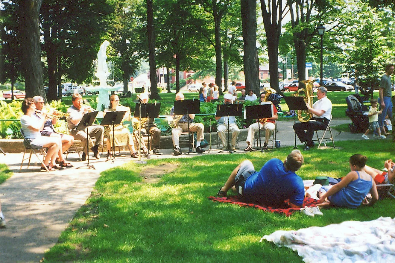 A band plays as picnickers listen in Gibson Park, Sackets Harbor, New York, via Wikimedia Commons - Public Domain