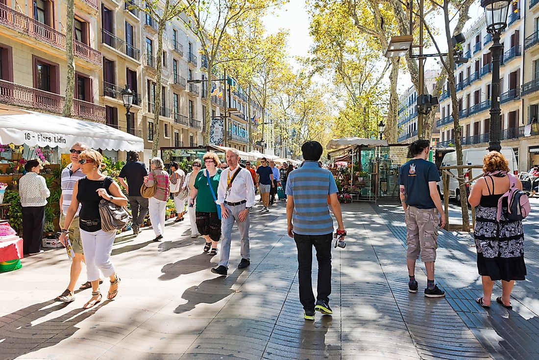 People walk the street of Barcelona, Spain. Editorial credit: Valeri Potapova / Shutterstock.com. 