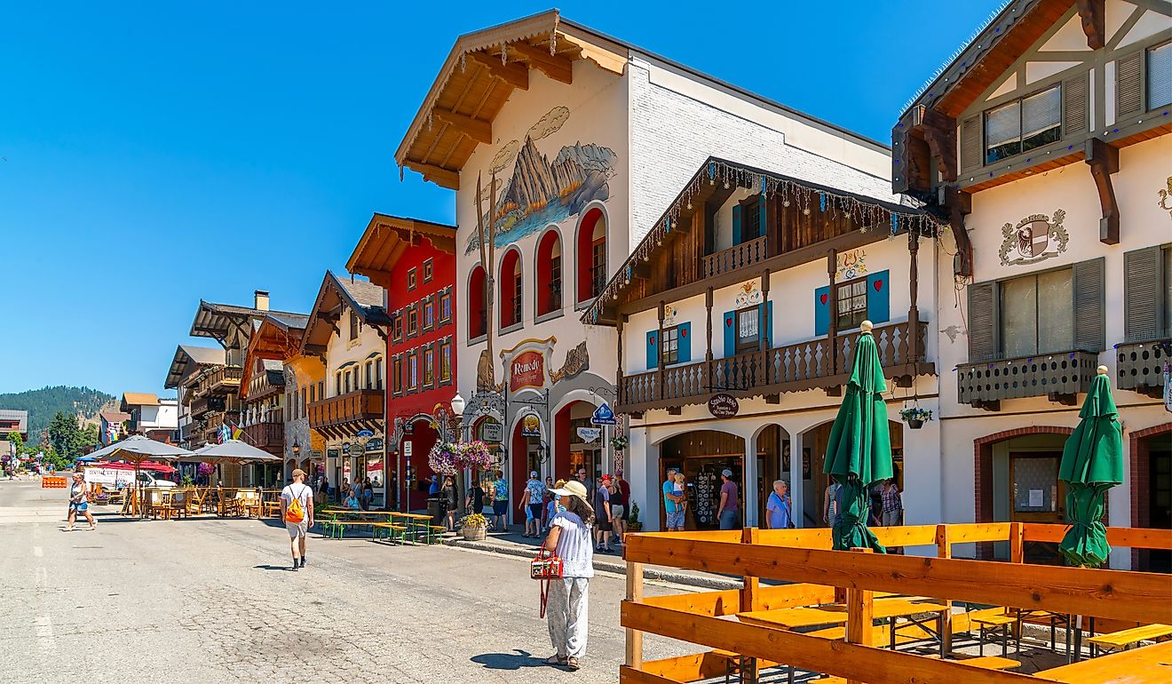 Shops and sidewalk cafes line the quaint Bavarian-themed main street of the tourist resort town of Leavenworth, Washington. Editorial credit: Kirk Fisher / Shutterstock.com. 