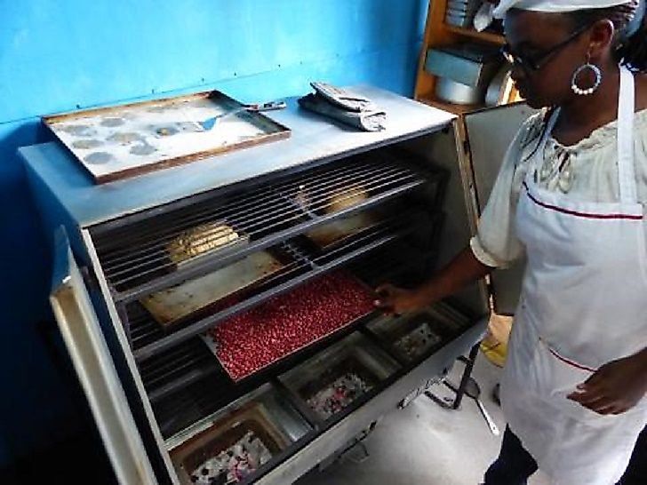 A South Sudanese baker uses a biomass-fueled stove financed in part by a nongovernmental organization.