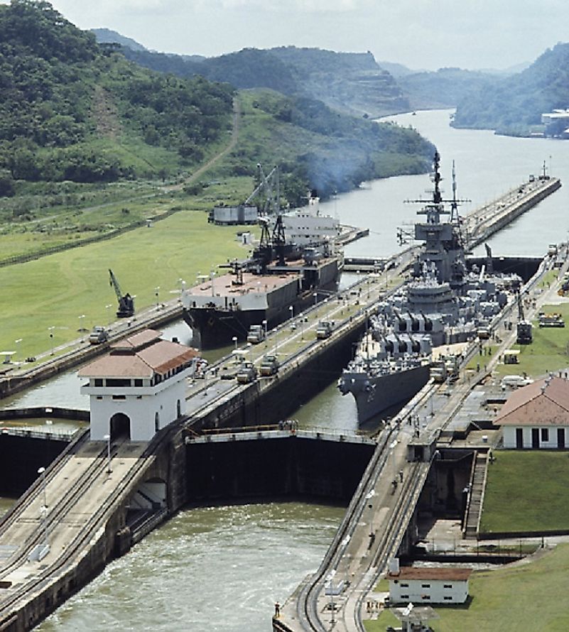 Locks lowering a warship as it passes between sections of the Panama Canal with different water levels.