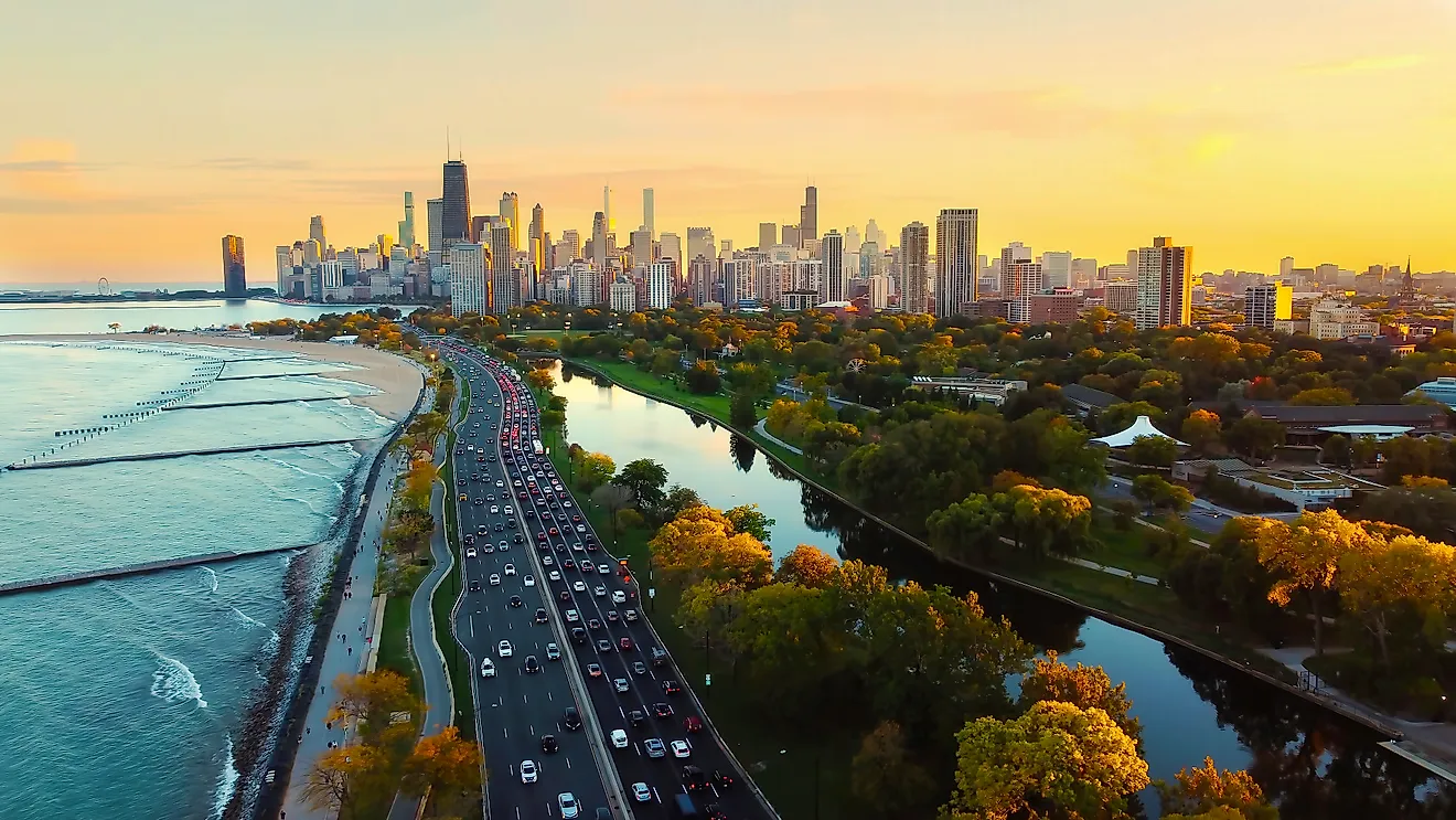 Aerial view of Chicago skyline at sunset, showing Lake Michigan shoreline