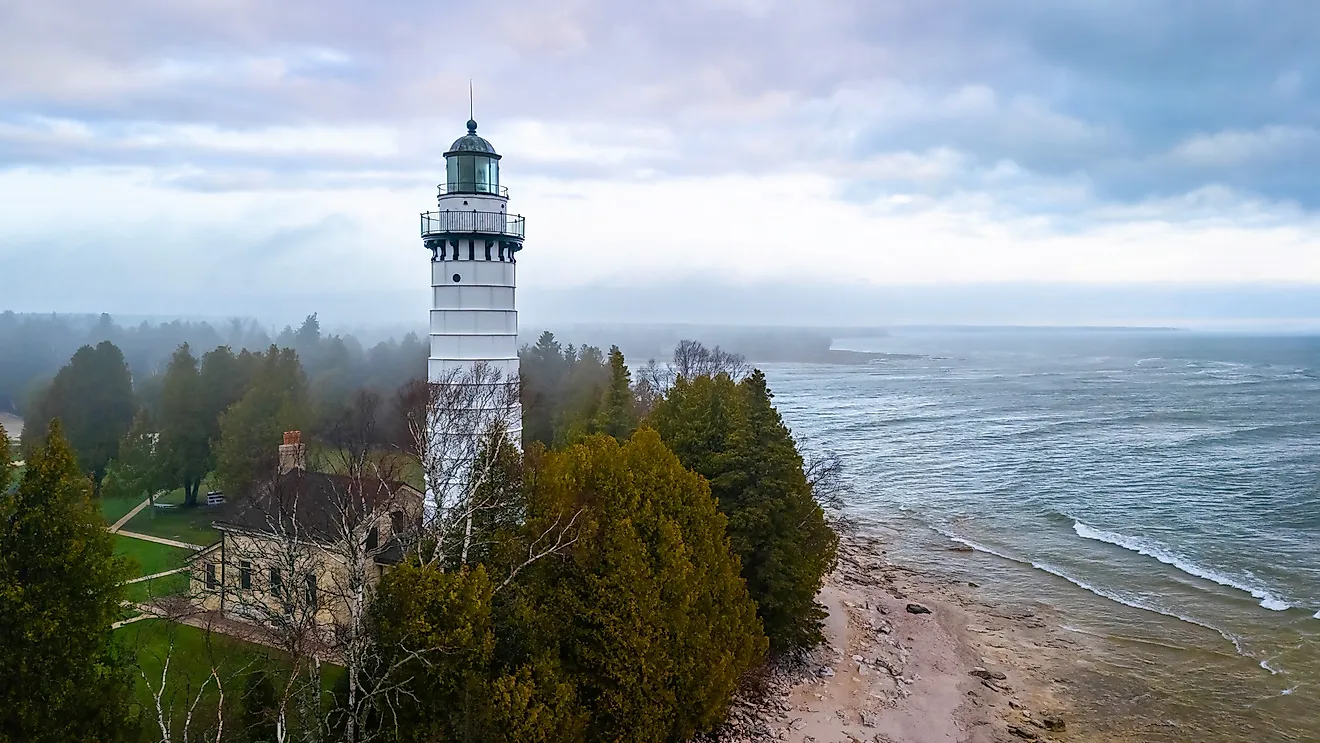 Aerial image of Cana Island Lighthouse in Wisconsin captured on a foggy day along Lake Michigan shoreline. Image by Photo Spirit via Shutterstock. 