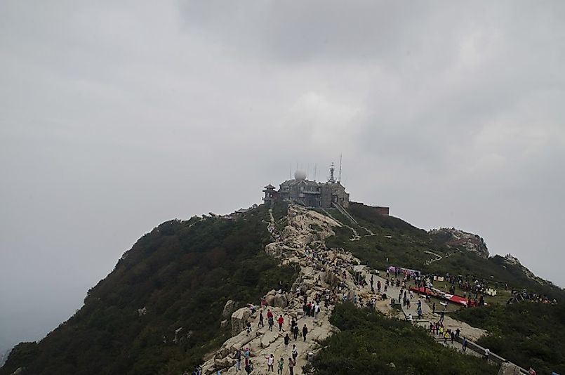 Tourists flock to the mist-covered heights of Mount Tai Shan.