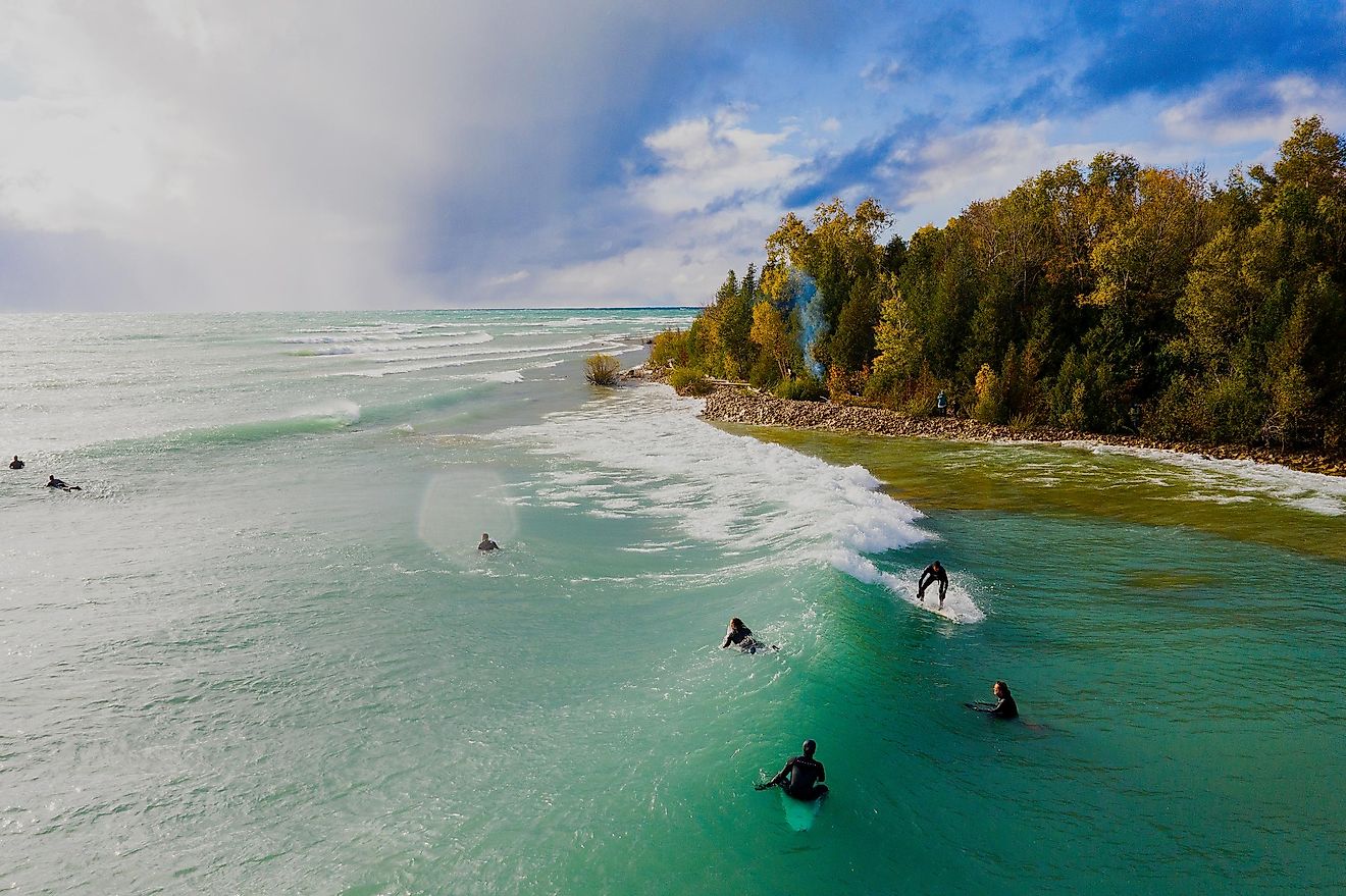 Aerial view of a group of Great Lakes surfers catching waves during an autumn storm at Lake Huron.