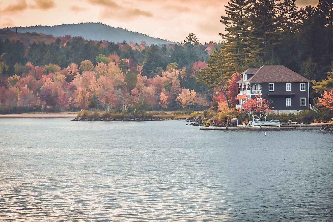 Long Lake in the Adirondacks, New York, showcasing brilliant, colorful foliage during the fall season.
