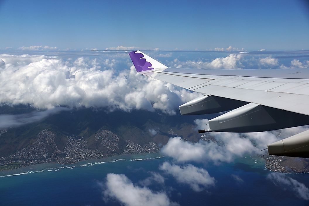 A Hawaiian Airlines jet flying over Honolulu, Hawaii.