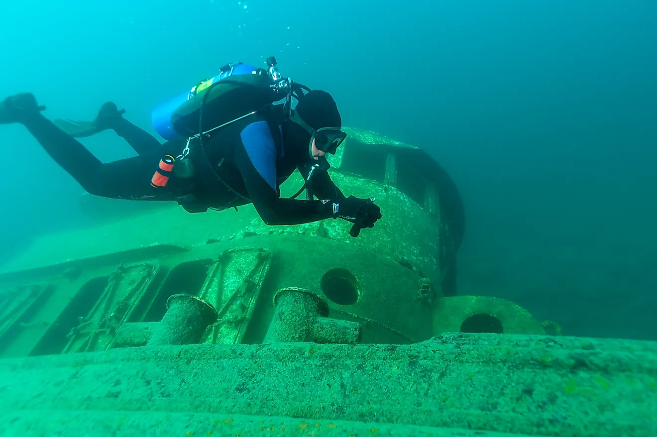 Diver exploring a shipwreck in Grand Island Harbor Bay, Lake Superior. 