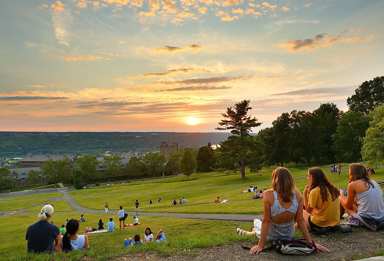 Students at Libe Slope watching sunset on campus of Cornell University in Ithaca. Image credit Jay Yuan via Shutterstock.