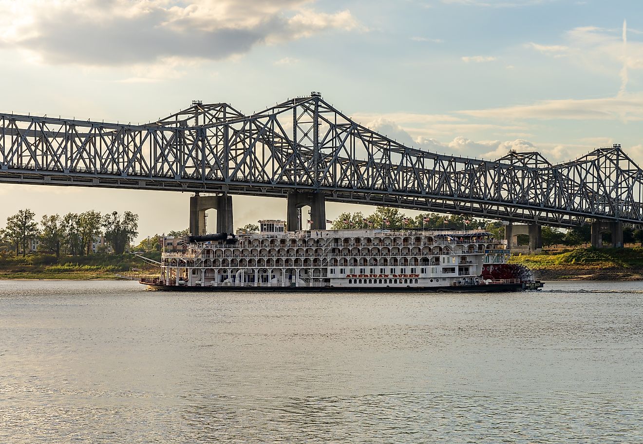 Natchez, Mississippi: Paddle steamer river cruise boat, American Queen, departs under the interstate bridge. Editorial credit: Steve Heap / Shutterstock.com