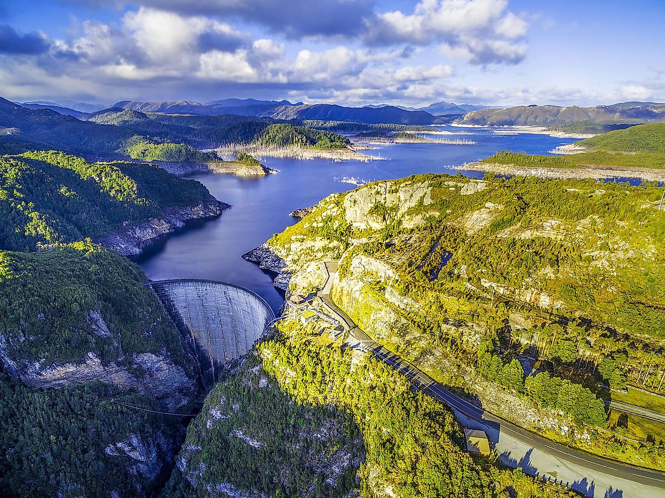 Aerial view of Gordon Dam and lake at sunset in Tasmania, Australia.