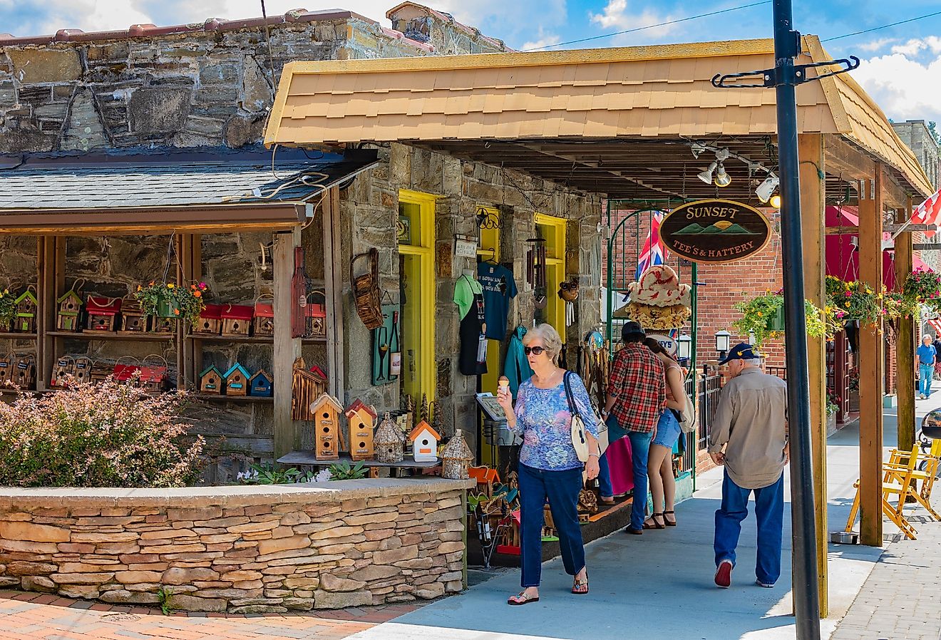 Tourists pass The Sunset Tee's & Hattery shop on Main St. in Blowing Rock, North Carolina. Image credit Nolichuckyjake via Shutterstock