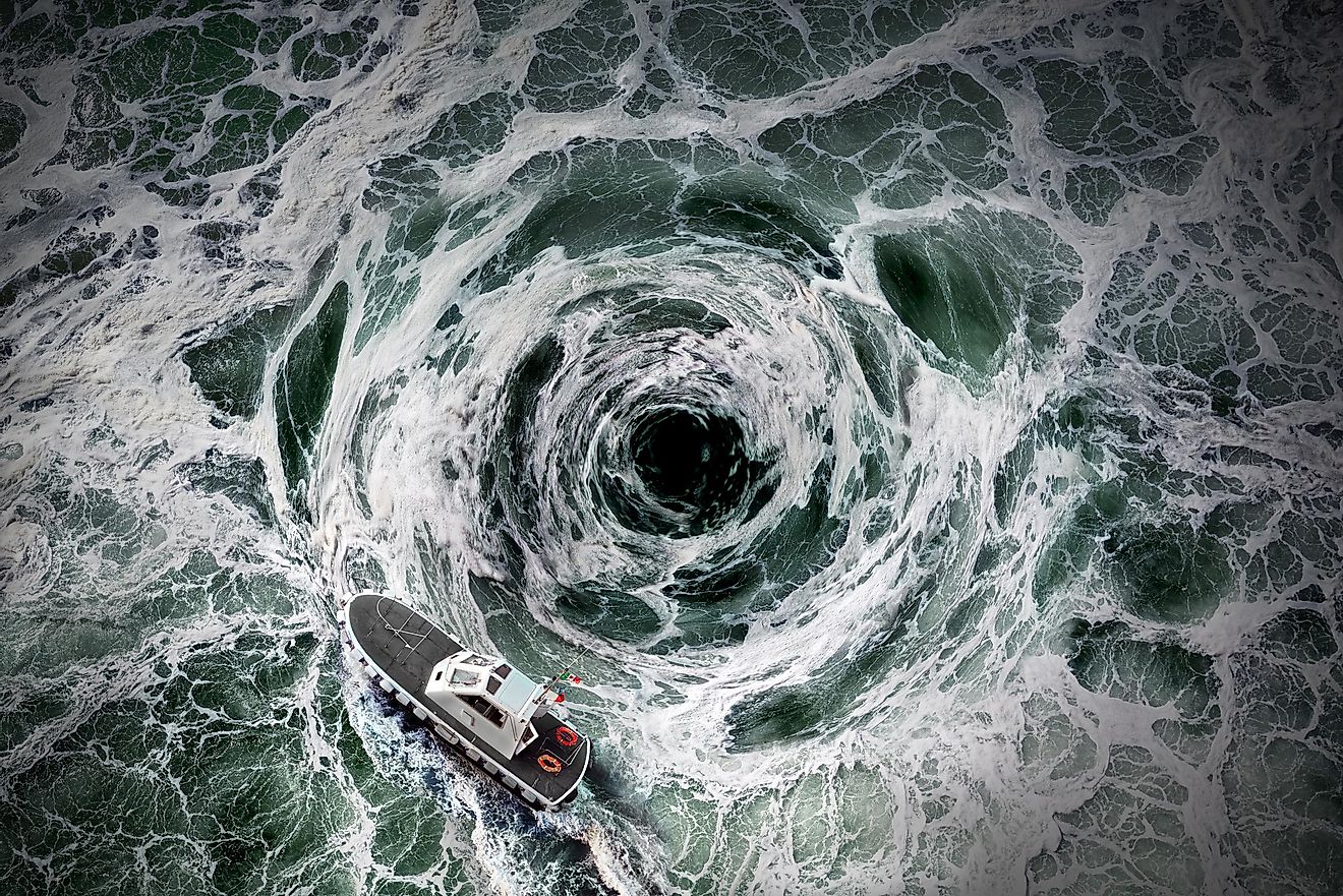 A whirlpool in the ocean with a boat dangerously nearby.