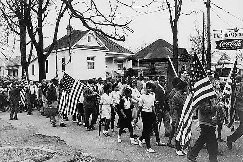 Participants, some carrying American flags, marching in the civil rights march from Selma to Montgomery, Alabama in 1965