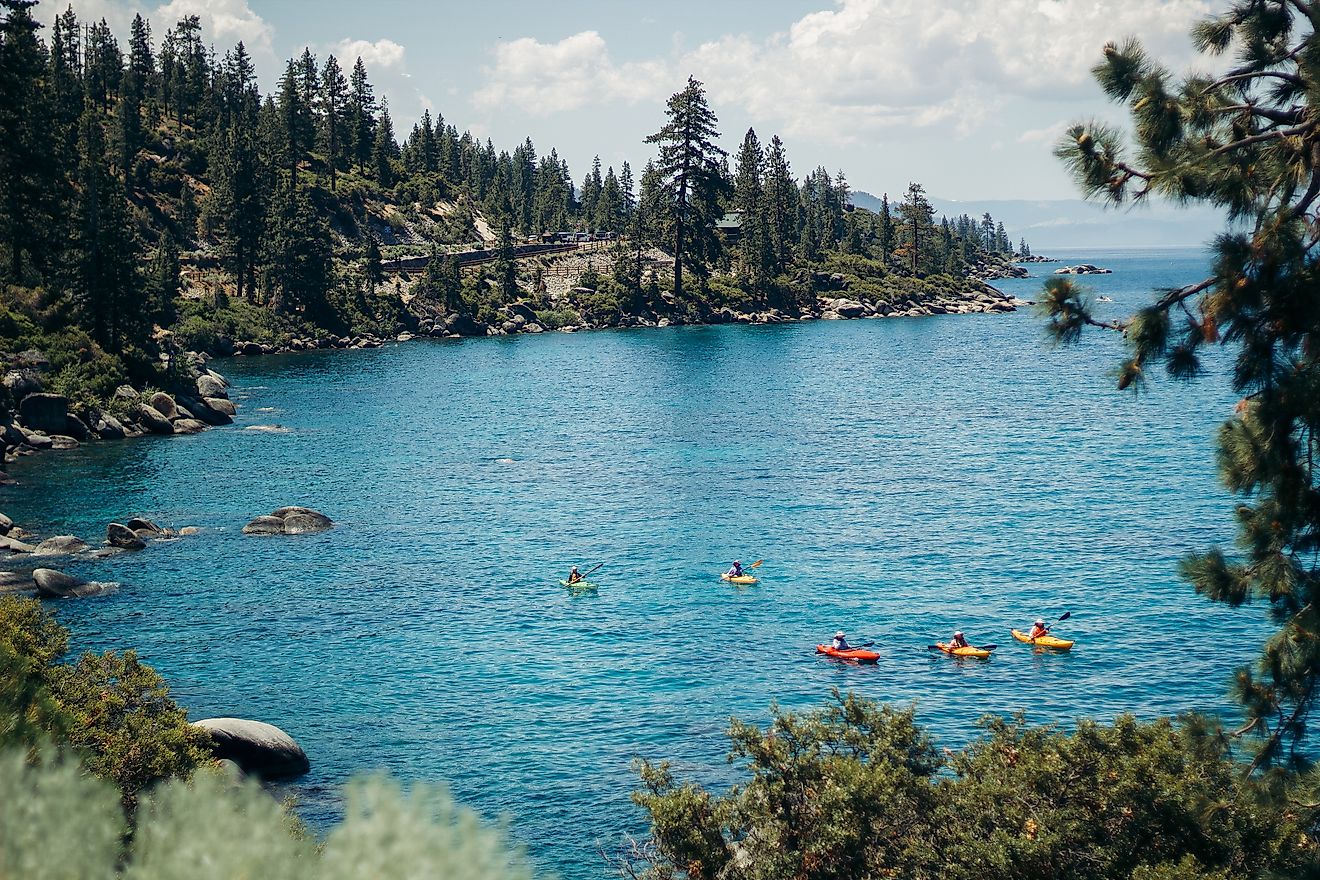 Colorful paddle boarders on the bright blue waters of Lake Tahoe