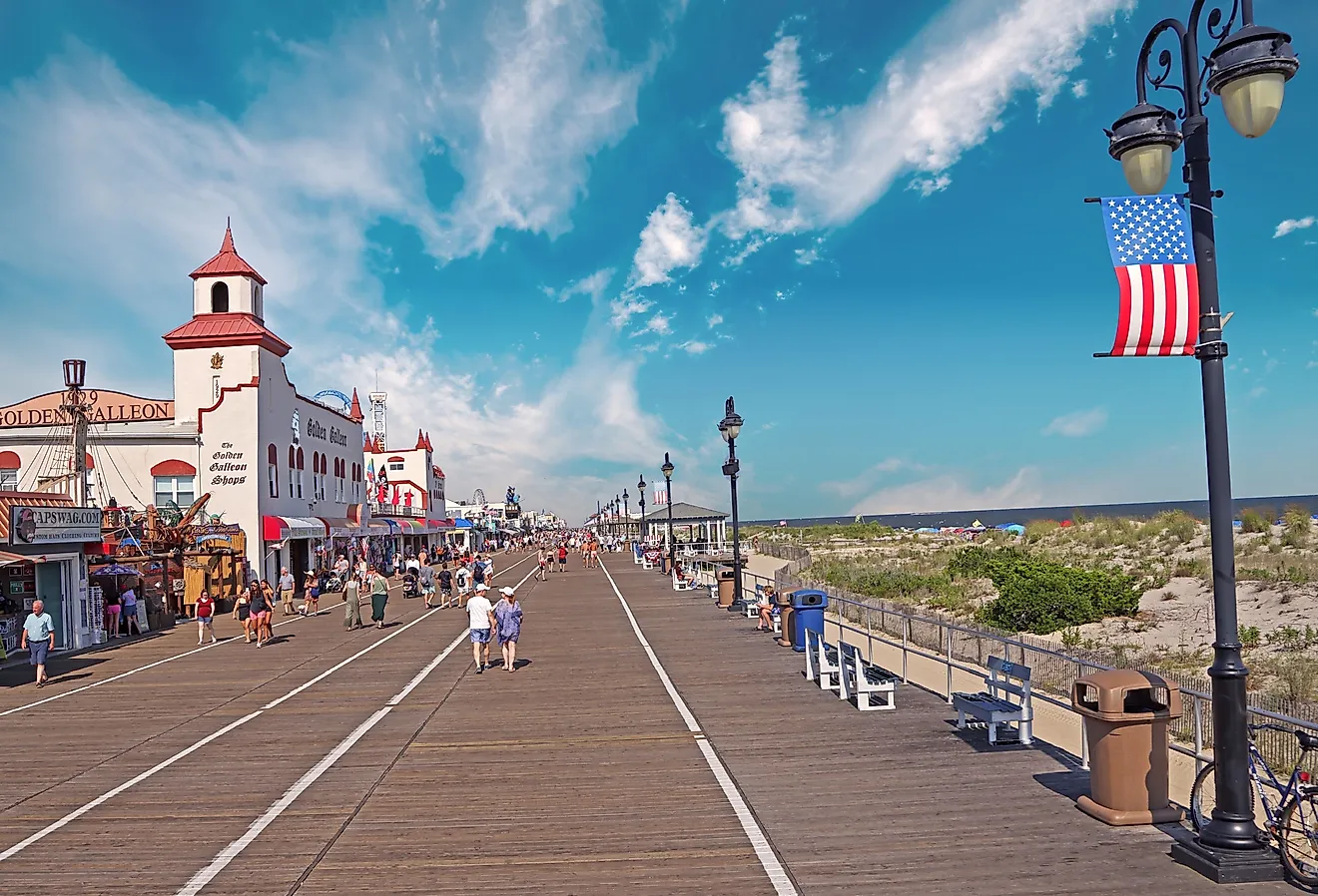 People walking along the famous boardwalk in late afternoon in Ocean City, New Jersey. Image credit: Vlad G via Shutterstock.