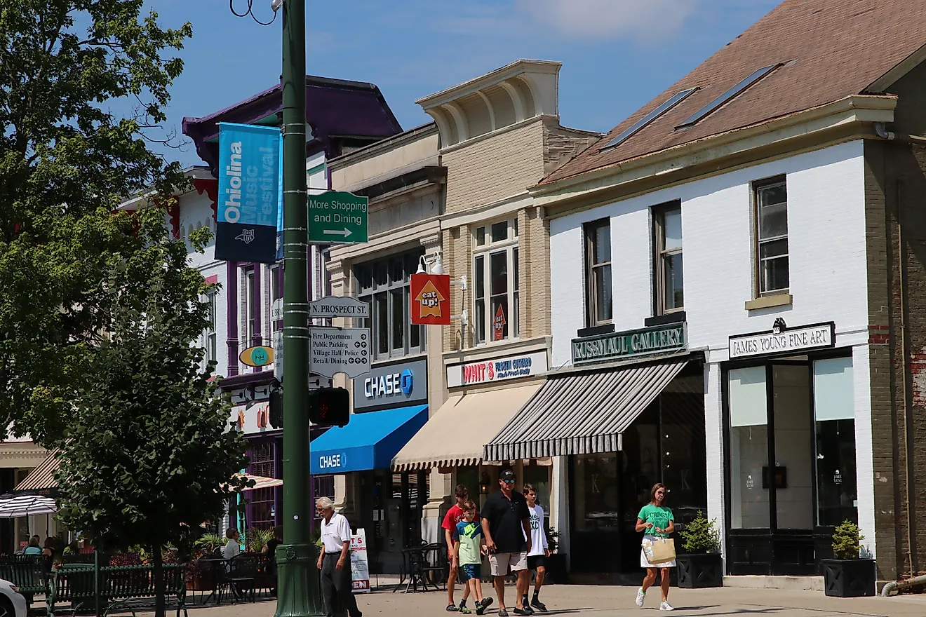 Shops, businesses, and dining establishments with sidewalk seating line the downtown block of Granville, Ohio. Editorial credit: Eric Glenn / Shutterstock.com