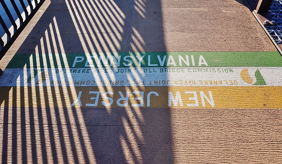 Boundary line between New Jersey and Pennsylvania on a bridge spanning the Delaware River.  Editorial credit: EQRoy / Shutterstock.com