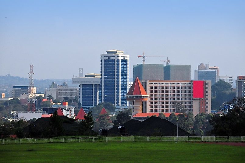 Suburban fields meet tall skyscrapers along the outskirts of Kampala.