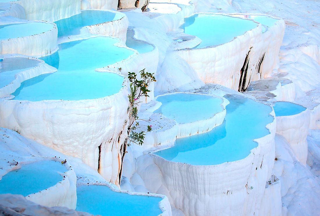 The vivid blue of Pamukkale's thermal pools contrast against the snow-white limestone formations.