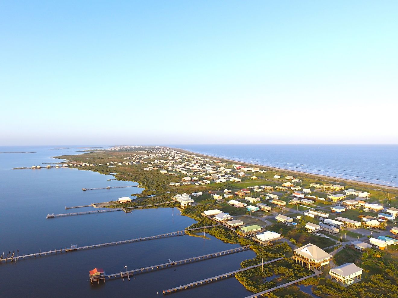 Stilt houses with long docks in the low-lying town of Grand Isle, Louisiana