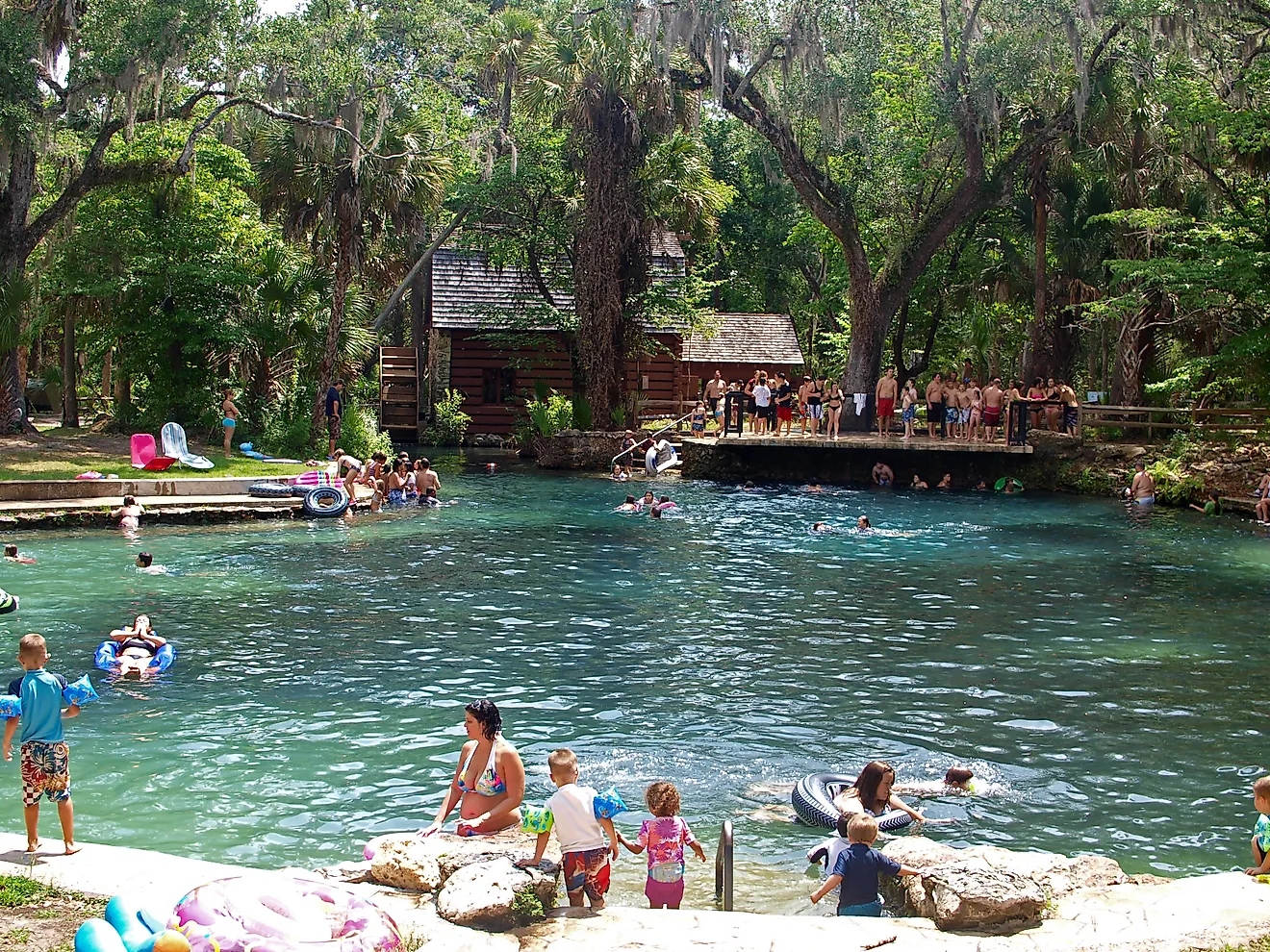 People enjoying in the spring fed pool of Juniper Springs Recreation Area. Image by Stillgravity via Shutterstock. 