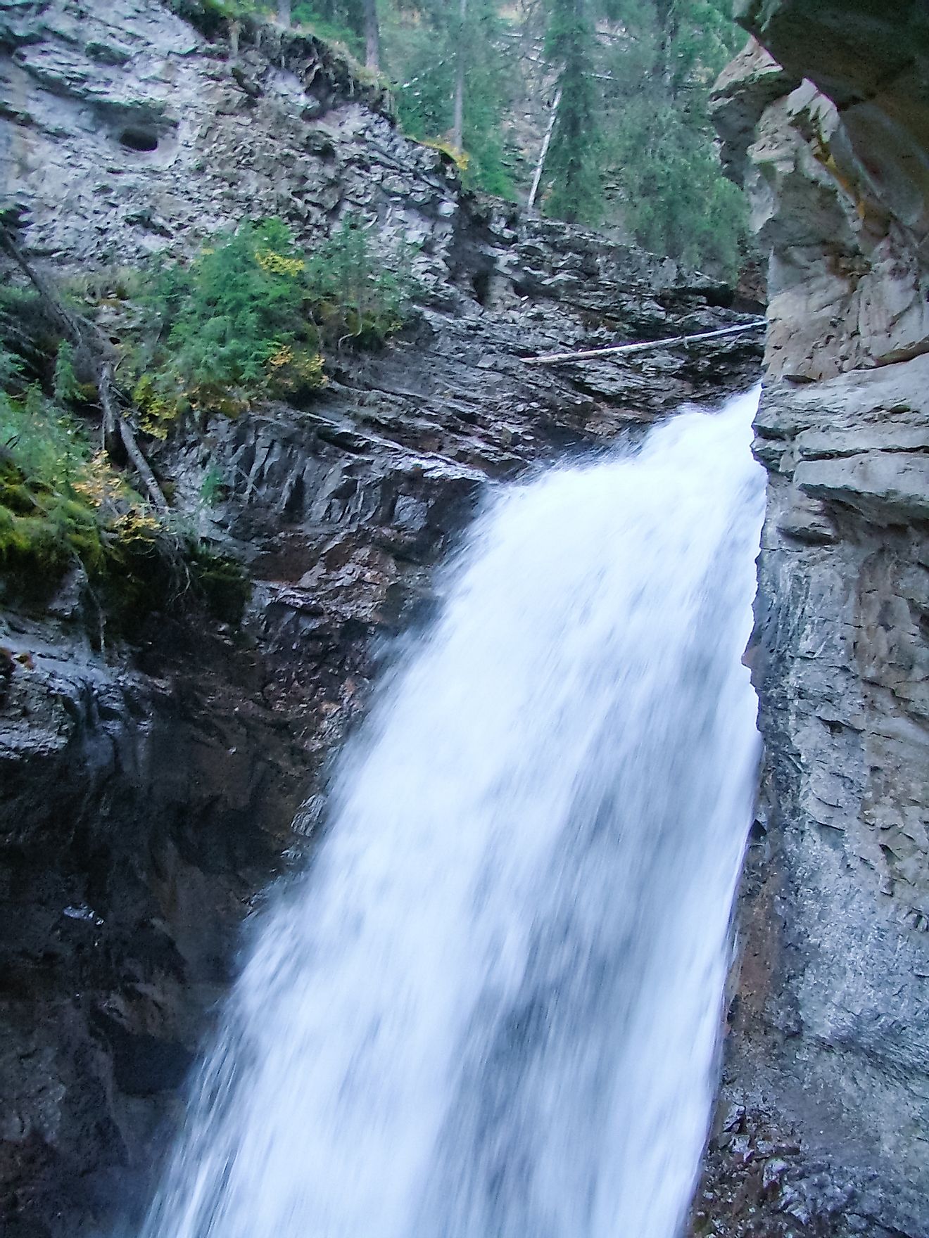The waters passing through Johnston Canyon and its falls in Alberta's Banff National Park ultimately drain into the Bow River.