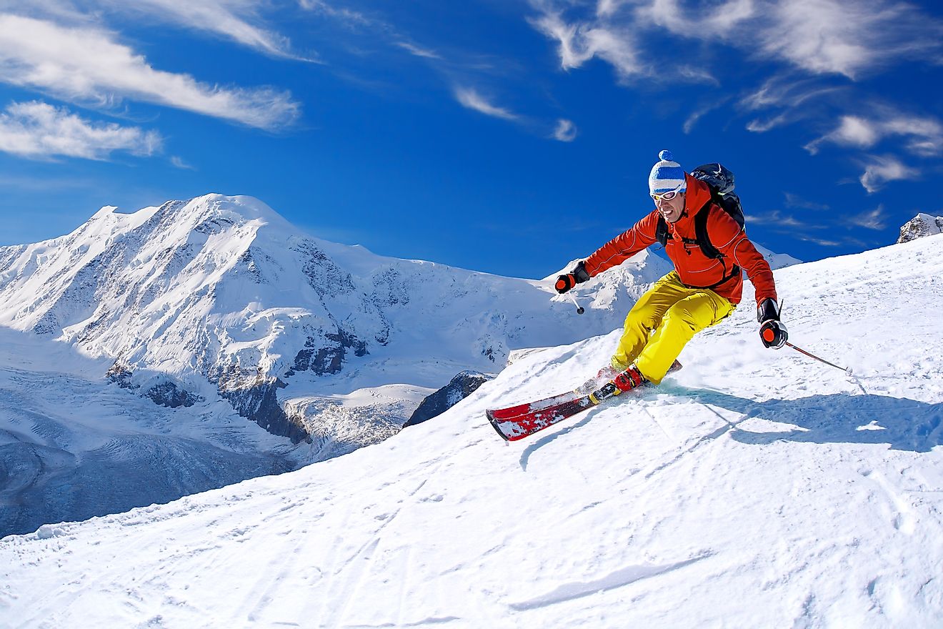 Skier skiing downhill in high mountains, Matterhorn area, Switzerland. Image credit: Samot/Shutterstock.com
