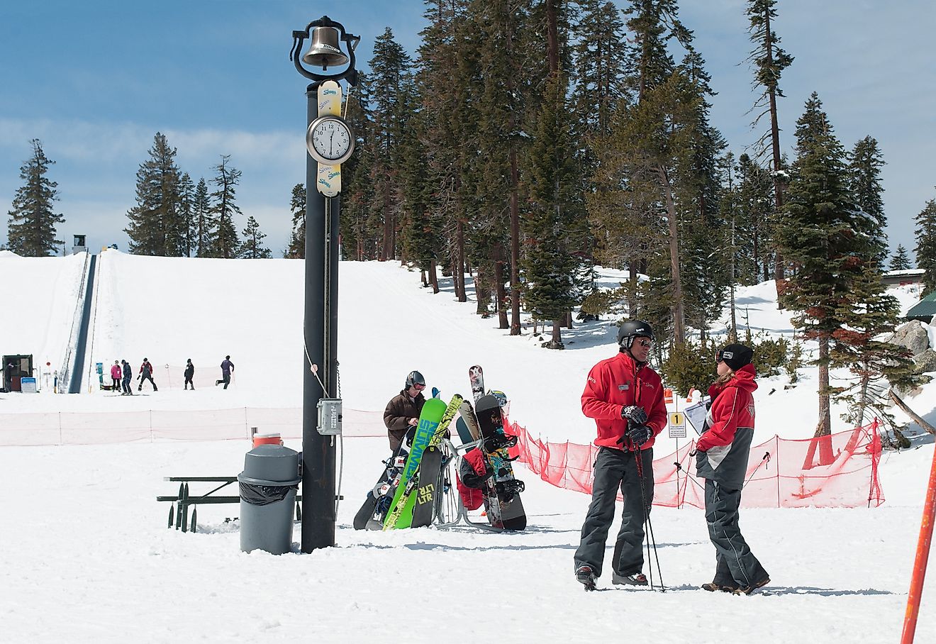 Sierra at Tahoe staff talking by pole with clock and bell. Image credit: D Coetzee/Flickr.com