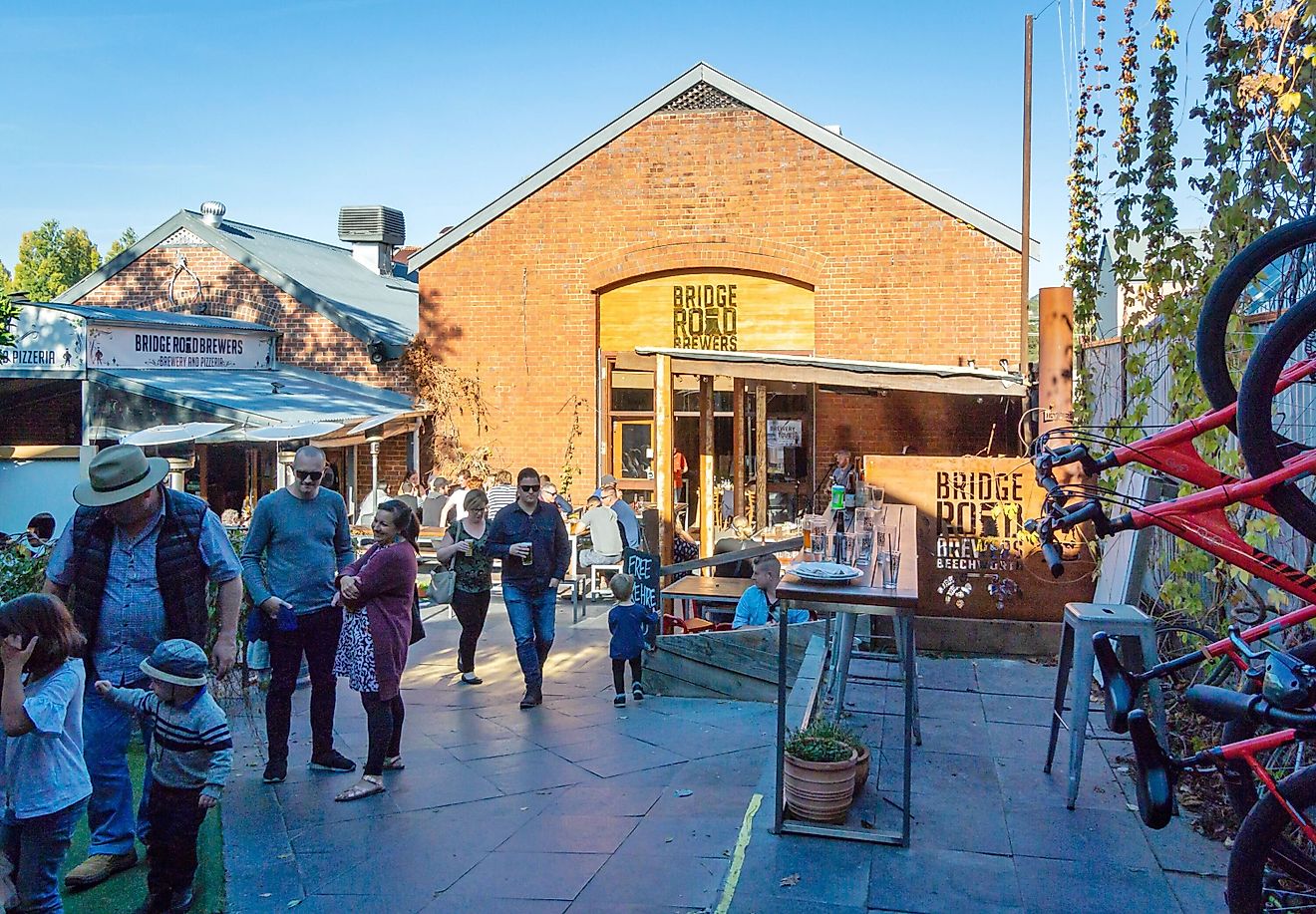 People drinking in the beer garden in Bridge Road Brewers in Beechworth, Victoria, Australia, via smartin69 / iStock.com