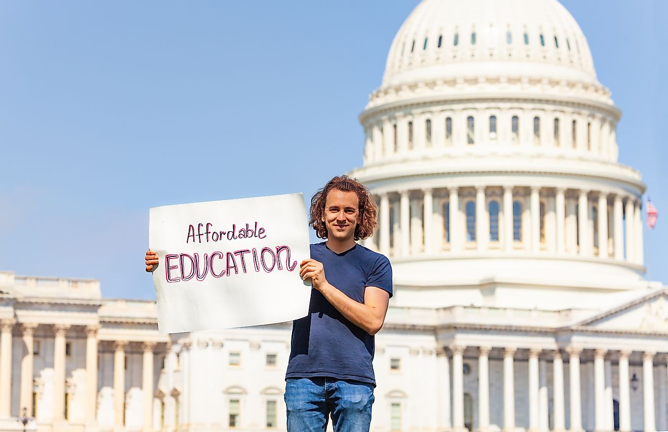 Protester holding sign for affordable education in hands. Image credit: Sergey Novikov/Shutterstock.com