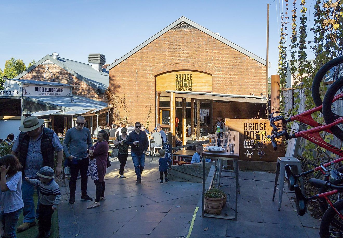 People drinking in the beer garden in Bridge Road Brewers in Beechworth, Victoria, Australia, via smartin69 / iStock.com