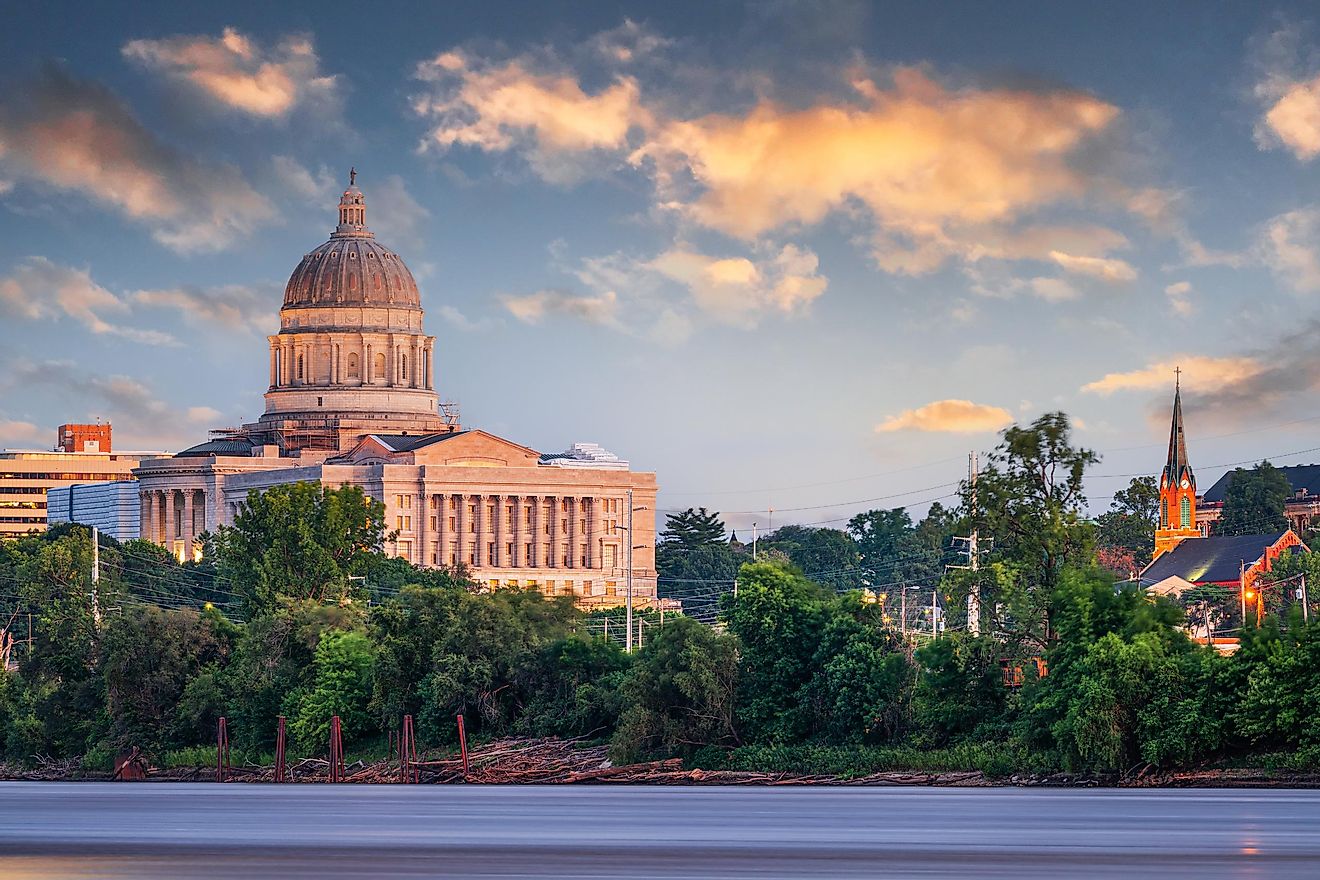 Jefferson City, Missouri, USA downtown view on the Missouri River with the State Capitol at dusk.