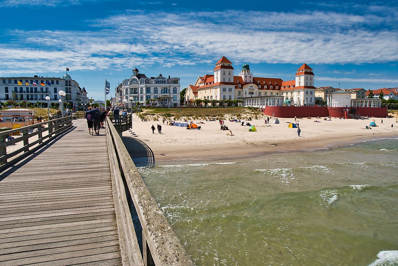 View of the pier with historic building along a sandy beach in Binz, Germany. Image credit: Rico Markus / Shutterstock.com