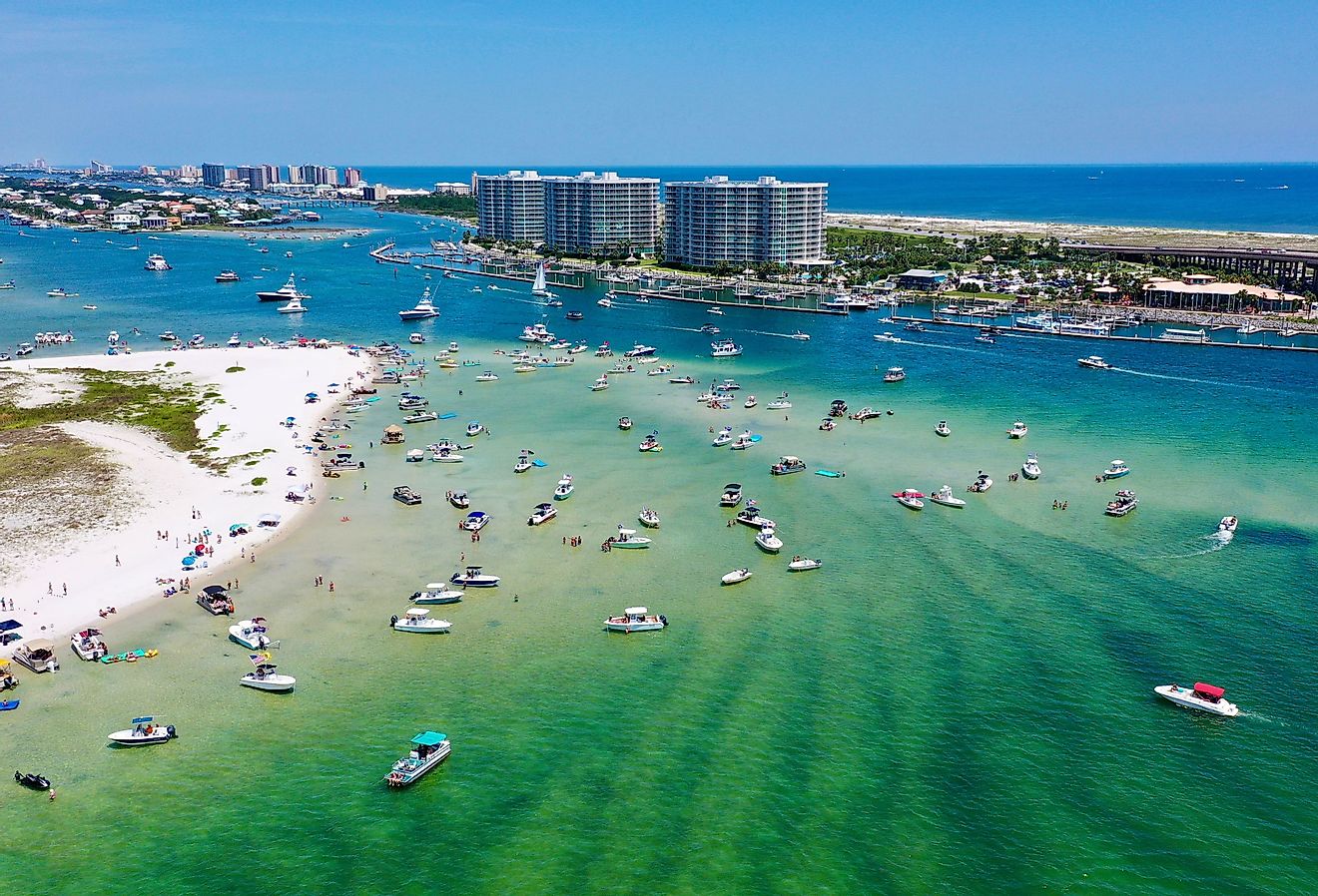 Aerial view of boats and people on the water and sandy beaches at Orange Beach, Alabama.