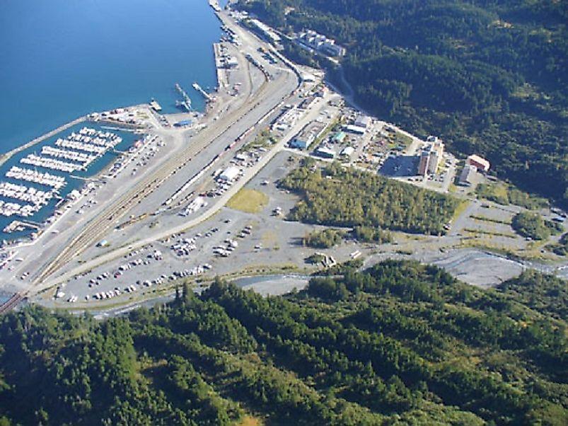 Aerial view of Whittier and its harbor, photo courtesy of whittieralaska.gov. Note the large residential building (Begich Towers) in the center-right of the image.