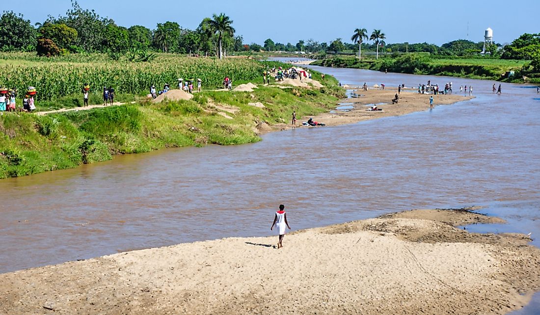 People crossing the Dajabón River between Haiti and the Dominican Republic. Editorial credit: Sandra Foyt / Shutterstock.com