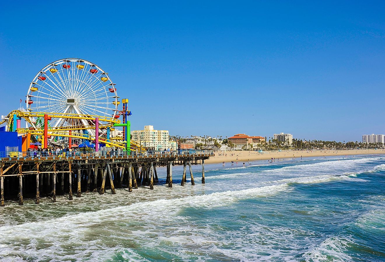 View of the Santa Monica pier in California, which features an amusement park and beach. Image credit Mark and Anna Photography via Shutterstock.