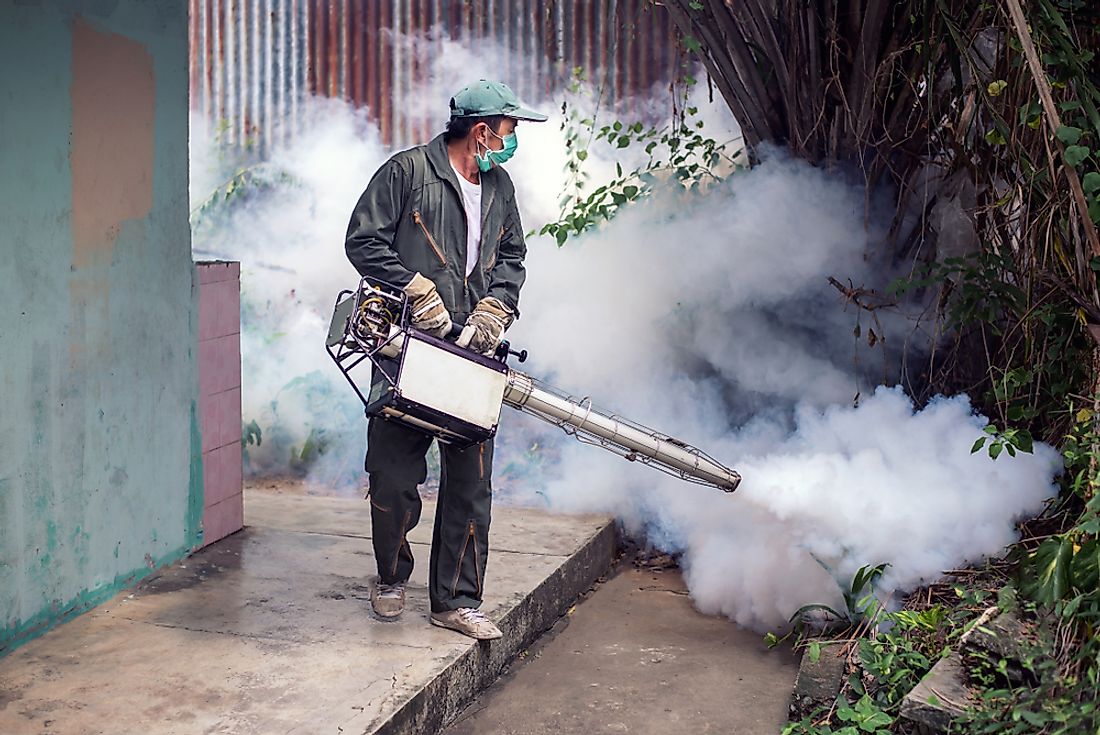 The man is fogging to eliminate mosquito for preventing spread dengue fever.
