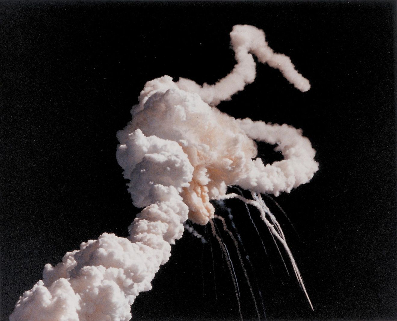 Space shuttle Challenger disaster. Space shuttle exhaust plumes entwined around a ball of gas after a few seconds after the explosion caused by ruptured O-rings. Imagecredit: Everett Historical / Shutterstock.com