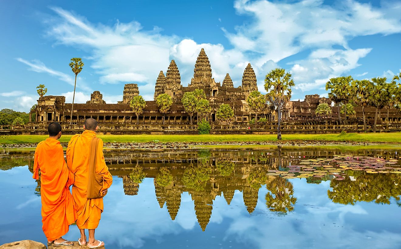 Buddhist monks in front of the reflection pool at Angkor Wat, Cambodia.