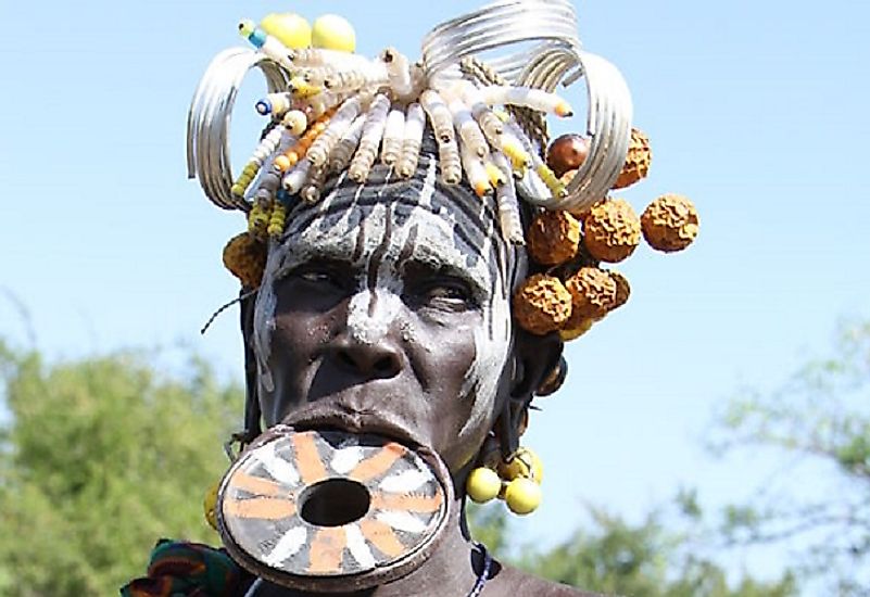 An elder Mursi women adorning one of the iconic pottery lip plates of her people.