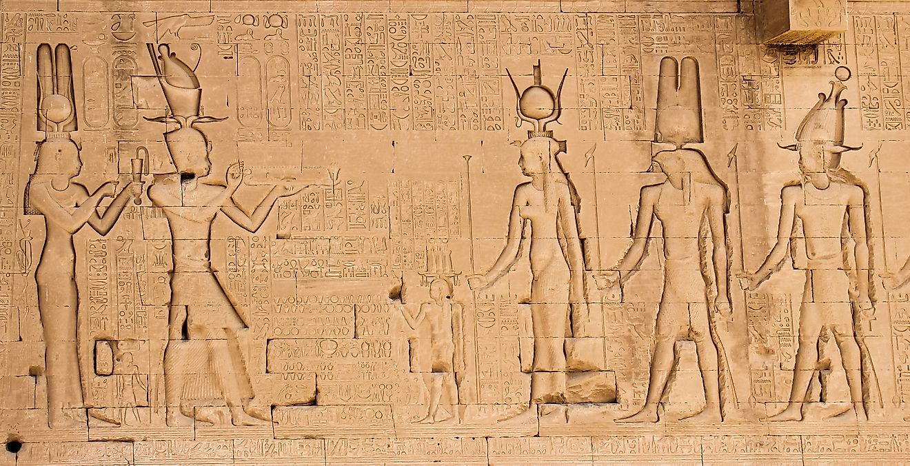 The south wall of the temple of Hathor at Dendera with lion-headed waterspouts. Cleopatra and her son Caesarian (on the left side)