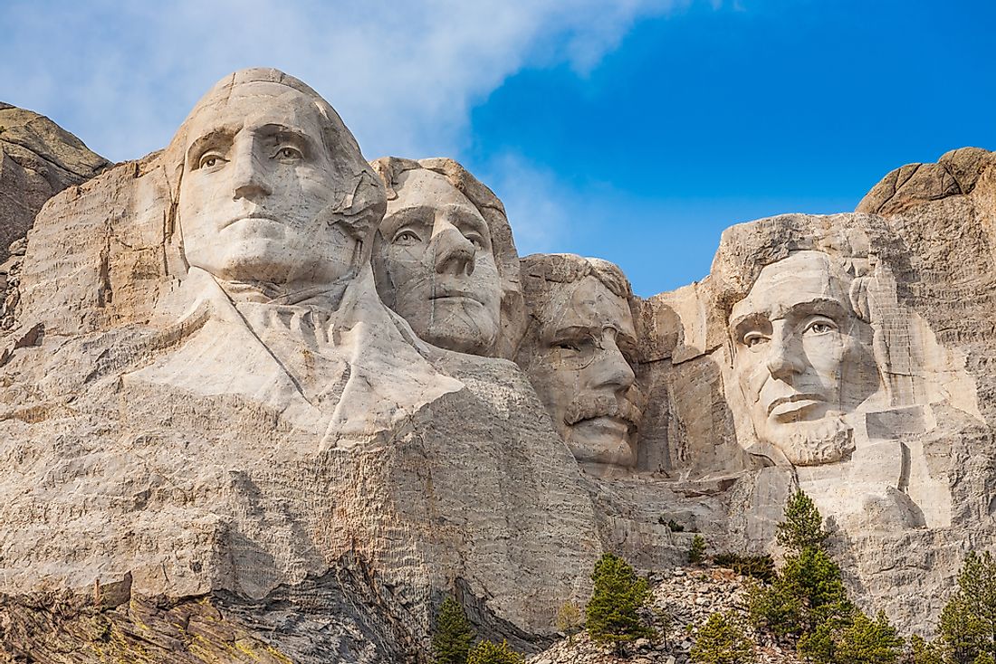 Mount Rushmore sculptures of past-presidents George Washington, Thomas Jefferson, Theodore Roosevelt, and Abraham Lincoln.